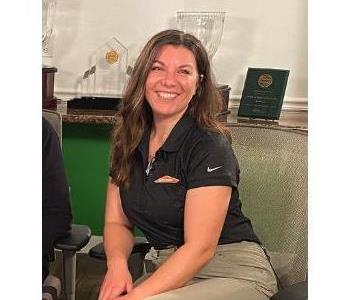 Smiling adult female with brown hair, wearing Servpro logo'd polo shirt