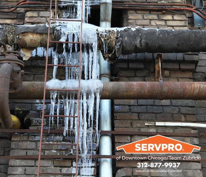 Frozen pipes are seen on an exterior wall.