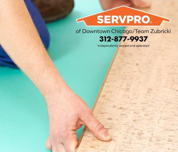 A person installs mold-resistant cork flooring.